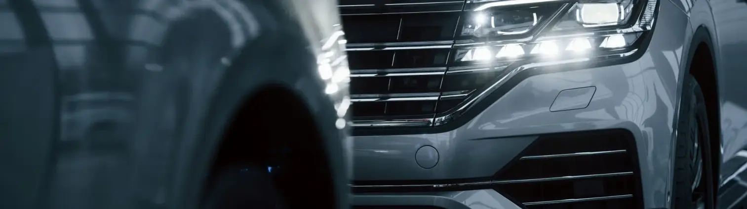 powerful-headlights-particle-view-modern-luxury-cars-parked-indoors-daytime powerful-headlights-particle-view-modern-luxury-cars-parked-indoors-daytime